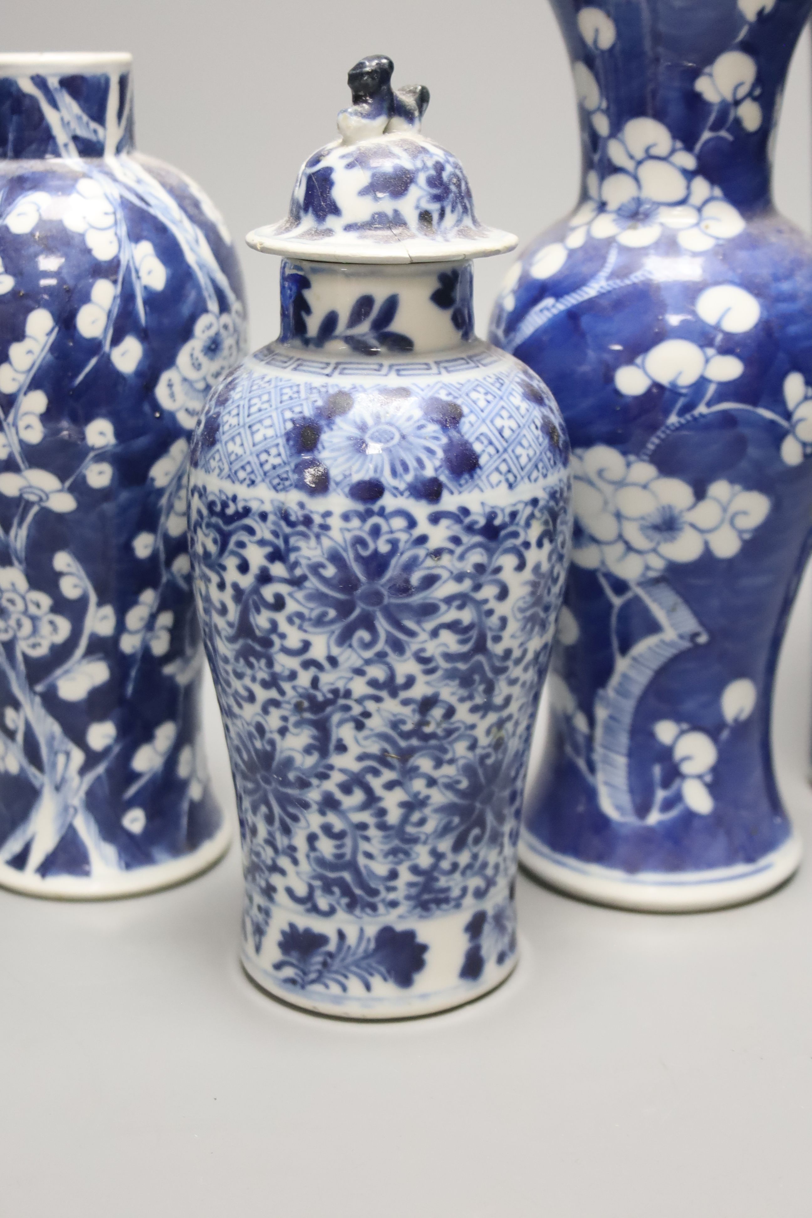 Four Chinese prunus pattern vases and a vase and cover, tallest 26.5cm